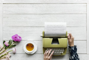 Aerial view a woman using a retro typewriter